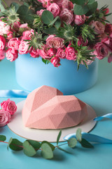 stylish modern design pink heart shaped cake on blue background with roses