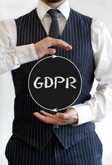 Businessman holding sign with the word GDPR