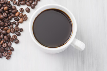 cup of black natural coffee, top view, coffee beans