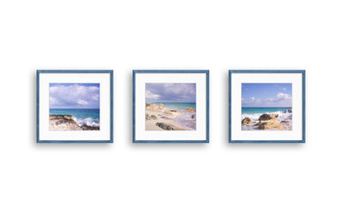 Frames with oceanview pictures, three wooden frameworks isolated on white  wall