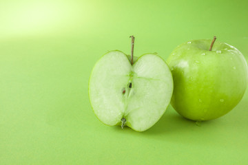 Perfect Fresh Green Apple Isolated on green Background with water drop in Full Depth of Field