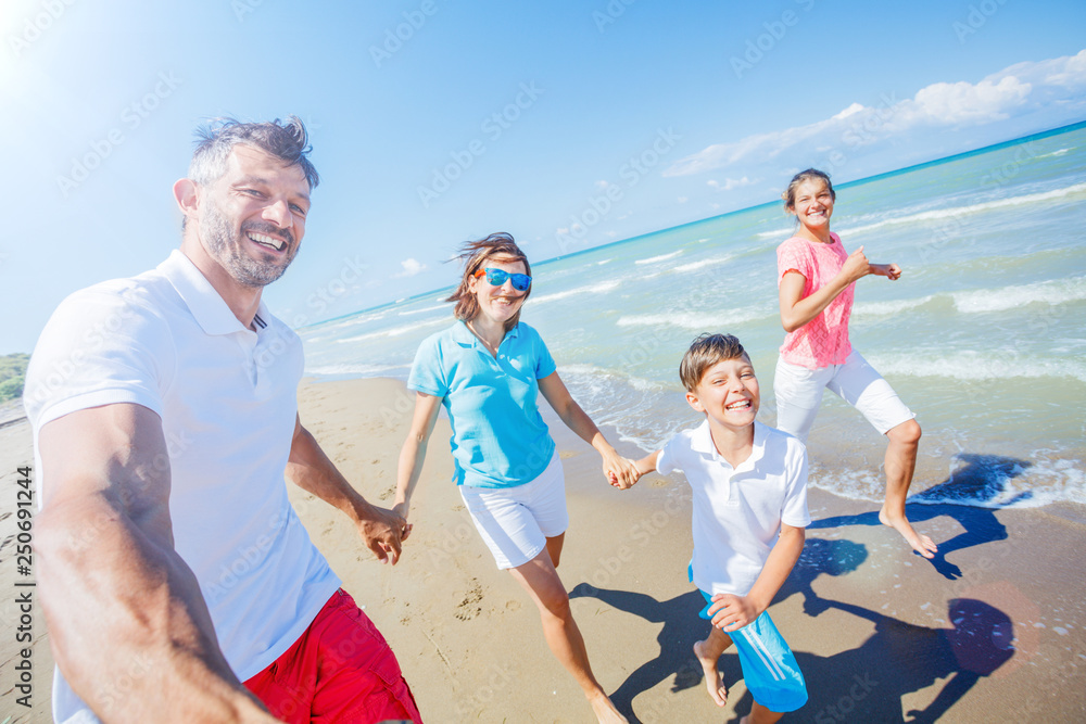 Wall mural happy family having fun at beach together. fun happy lifestyle in the summer leisure