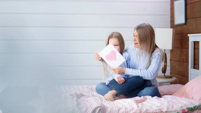 Full shot happy little girl congratulation her young mom to mother's day gift holiday postcard