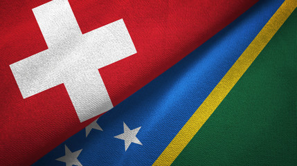 Switzerland and Solomon Islands two flags textile cloth, fabric texture