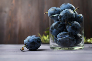 fresh plums on wooden table