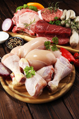 raw meat. Different types of raw pork meat, chicken and beef with spices and herbs
