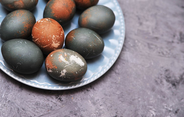 Eggs in plate on stone background.