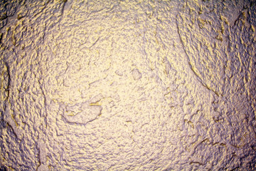 abstract golden grunge background. The texture of the wall of decorative plaster.