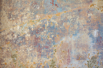 old wall with removed wallpaper and rest of paint