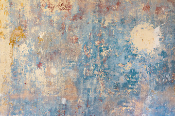 old wall with removed wallpaper and rest of paint