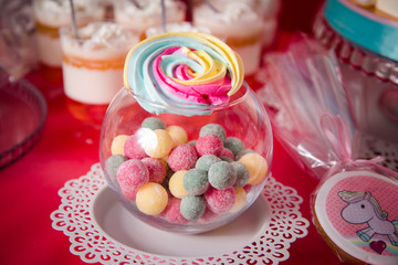 Candy bar with a lot of different candies and sweet cakes