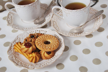 cookies with marmalade, sugar, seeds with tea for breakfast in retro cups