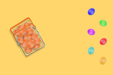 One full glossy metal market basket of fresh raw brown eggs on yellow table on kitchen. Top view. Business concept. Copy space for your text