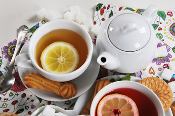 various cookies and biscuits baked at home in a container and tea in a retro cup with free space for text
