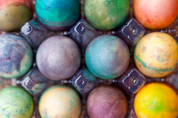 Group of Easter colored eggs in plastic container