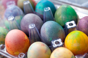 Group of Easter colored eggs in plastic container