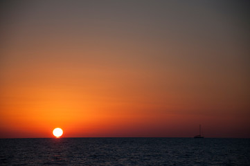 Sunset in the sea and a boat