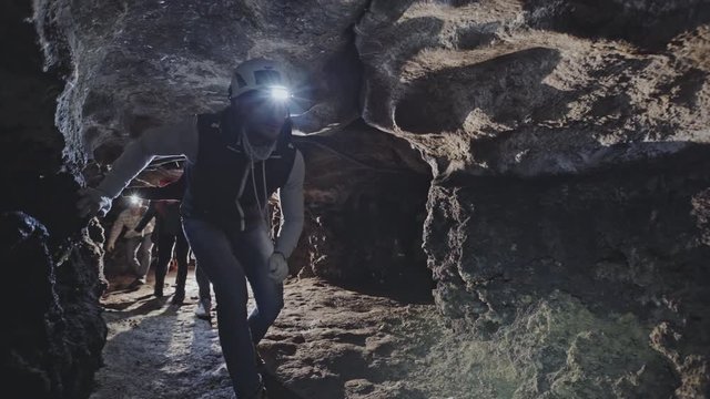 Group of cavers hiking through cave