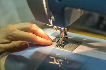 close up mechanism of sewing machine foot  with needle and thread