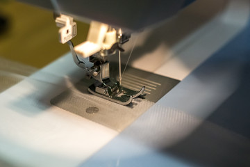 close up mechanism of sewing machine foot  with needle and thread