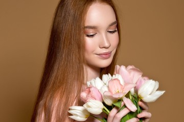 Woman with tulips bouquet and gift box. Birthday. March 8. Mother day.