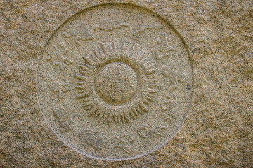 Horoscope wheel chart made from marble stone. Ancient stone zodiac wheel with signs around the sun symbol.