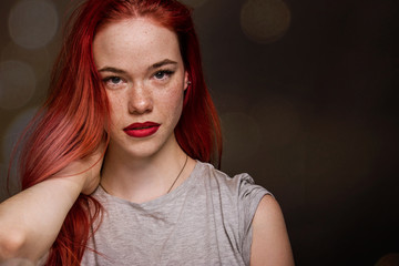 Fototapeta premium Beautiful natural freckle young girl with long red hair close up portrait 
