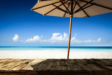 Desk of free space on beach and umbrella with shadow 