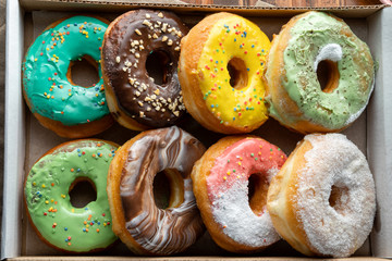 Delicious and tempting box full of colour donuts.