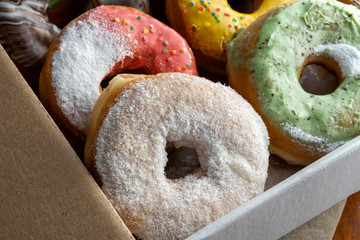 Delicious and tempting box full of colour donuts.