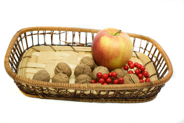 apples. cinnamon and walnuts on white background