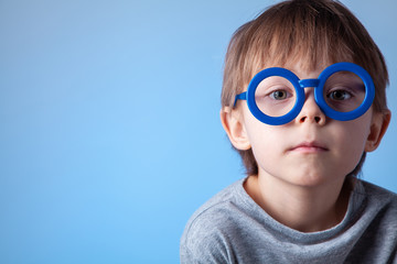  Portrait of a cute boy on a blue background.