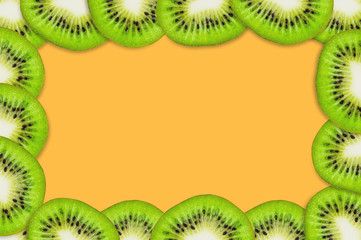 Fototapeta na wymiar Frame with pieces of sliced tasty beautiful ripe fresh kiwi fruit on orange table in kitchen. Top view. Cooking concept. Copy space for your text