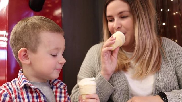 Happy family enjoying ice cream in cafe together
