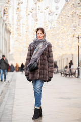 Fototapeta na wymiar Happy woman in fur mink coat
