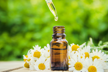 Chamomile extract in a small bottle. Selective focus.