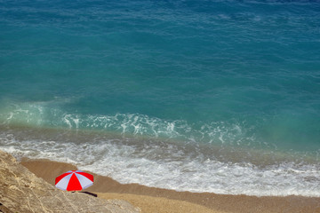 Beautiful beach with umbrellas for a holiday in Albania. Ionian Sea