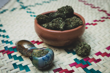 Smoking Marijuana in Pipe with Bowl of Cannabis Buds