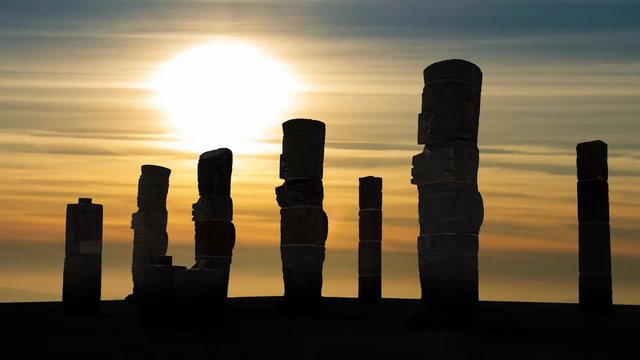 Atlantean columns or Toltec warriors on Pyramid of Quetzalcoatl in Ancient ruins of Tula de Allende, Sunset time lapse in Mesoamerican archeological site, capital of the Toltec Empire, Mexico