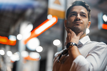 Young attractive businessman waiting for train in metro or subway.