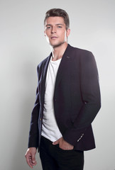 Studio portrait of a serious young man in suit
