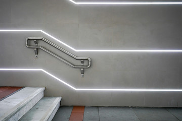 staircase in front of a led illuminated wall