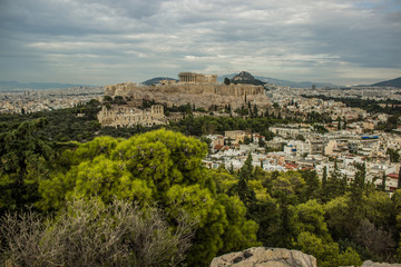 Fototapeta na wymiar Greece Acropolis ancient temple reconstruction concept photography Athens city view in cloudy panoramic foreshortening 