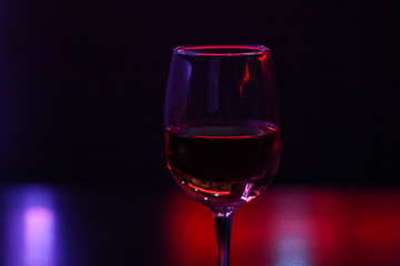 Cocktails A glass of wine. A beer rack with drinks. Night lighting of the institution. Purple Scythian in the background. Cafe. Bar.