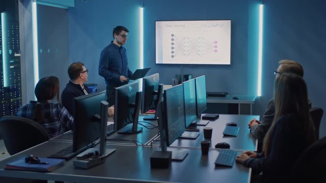 Team of Professional IT Developers Have a Meeting, Speaker Talks about New Blockchain Based Software Development Shown on TV. Concept: Software Development, Deep Learning, Artificial Intelligence