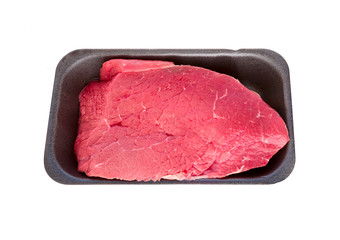 Fresh raw Beef isolated on white.  Plastic tray with beef meat sirloin.