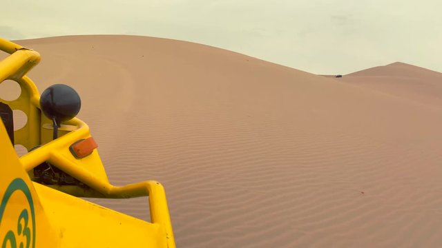 POV driving a dune buggy on Huacachina desert in Ica Region of Peru, South America.