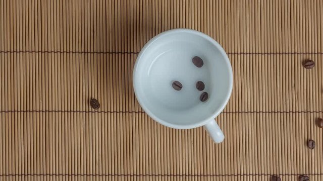 STOP MOTION: Coffee beans in a white cup