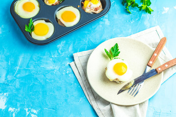 Baked eggs  in light plate and baking molds