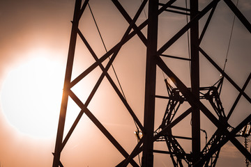 Power pylon array and details. Energy plant, red and white metal. Elctricity distribution grid, clean energy and local politics. National consumer supply for housing and cities. 